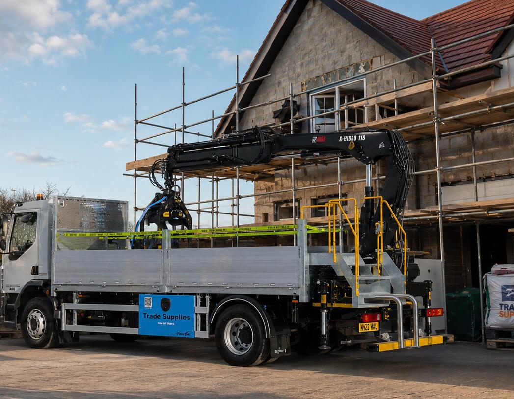 Merchant delivery truck with FleetVend 'Trade Supplies — now on board' cabinet, parked at a build site